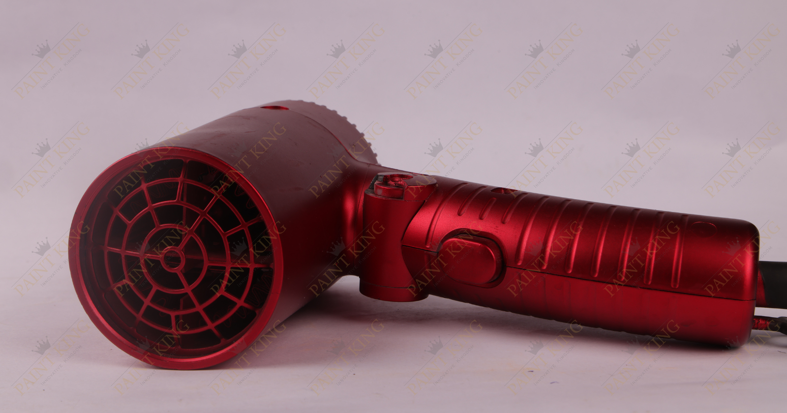 A hair dryer with a vibrant red body and a sleek design.