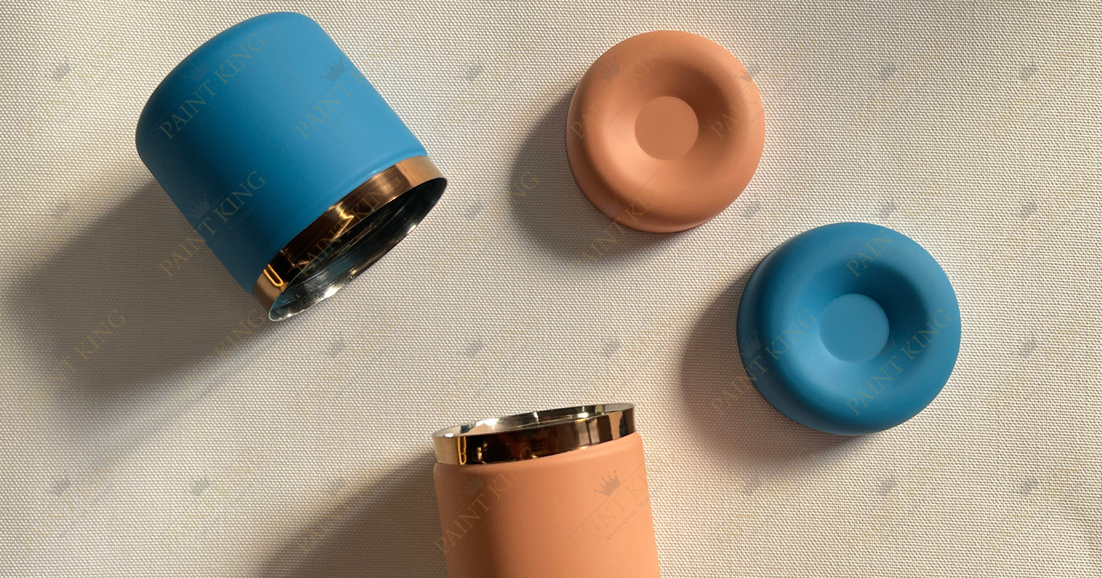 A collection of small steel containers with various spray-painted finishes