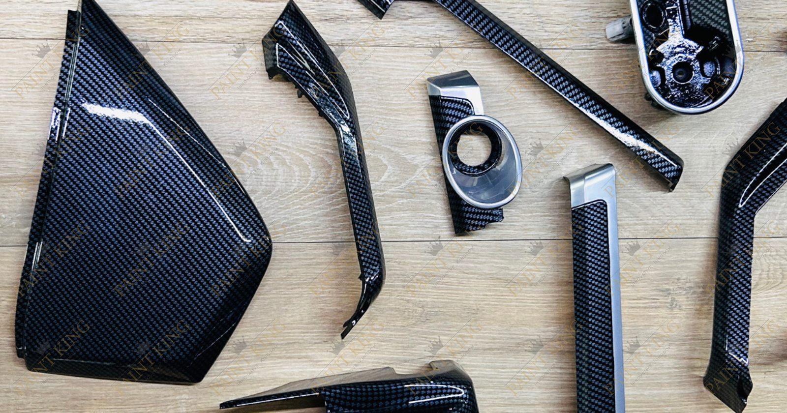 Various car interior parts with a sleek carbon fiber finish